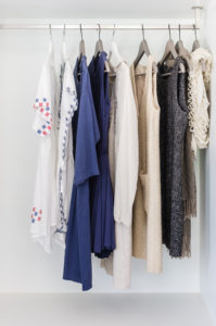 row of cloth hanging on coat hanger